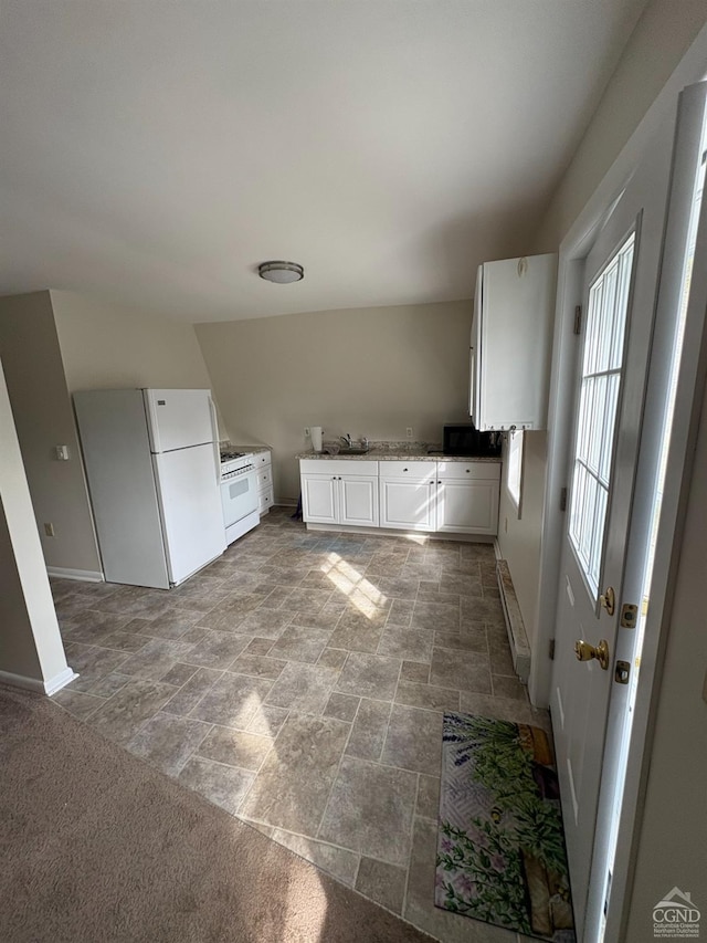 1013 Plank Rd, Averill Park, NY 12018 - kitchen with white appliances, baseboards, stone finish flooring, white cabinets, and a sink