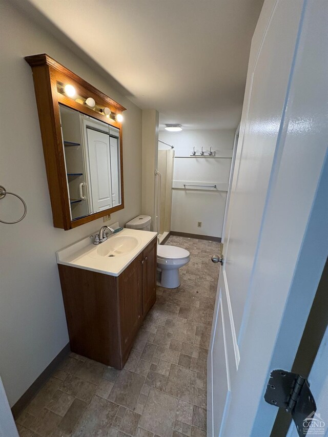 1013 Plank Rd, Averill Park, NY 12018 - full bath featuring toilet, vanity, baseboards, stone finish flooring, and a shower