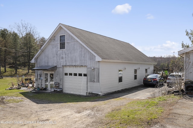 60-62 Stony Rd, Accord, NY 12404 - view of side of property featuring a detached garage, french doors, driveway, and roof with shingles
