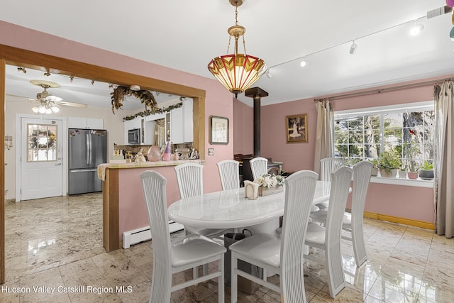60-62 Stony Rd, Accord, NY 12404 - dining area featuring a wood stove, a ceiling fan, rail lighting, and a baseboard radiator