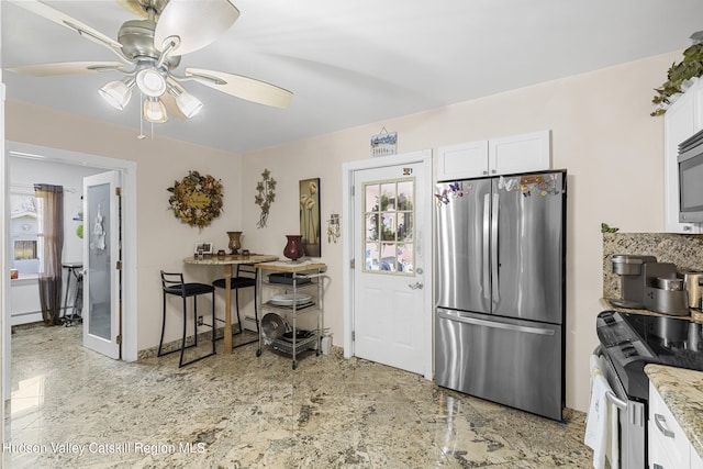 60-62 Stony Rd, Accord, NY 12404 - kitchen featuring light stone countertops, ceiling fan, white cabinetry, and stainless steel appliances