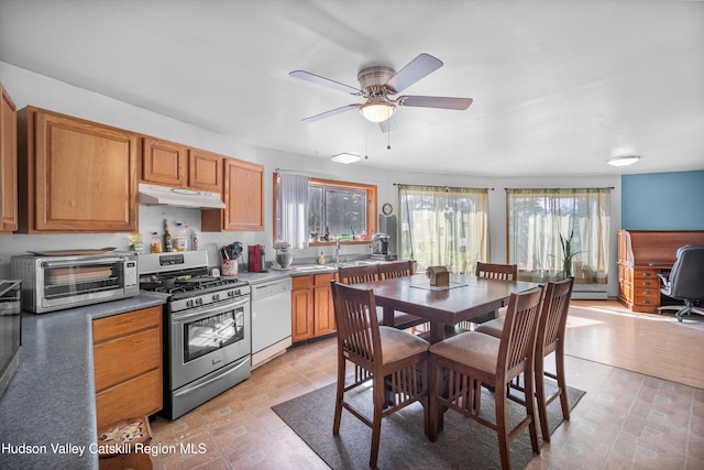 17 Boice Mill Rd, Kerhonkson, NY 12446 - kitchen featuring stainless steel range with gas cooktop, white dishwasher, under cabinet range hood, a ceiling fan, and a baseboard heating unit