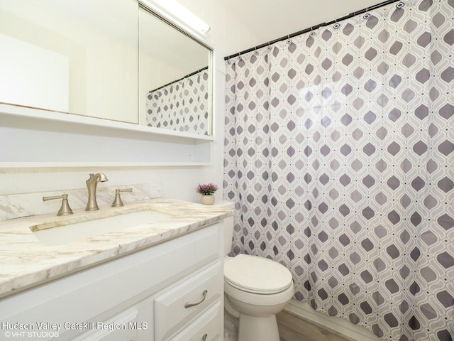 full bath with toilet, curtained shower, and vanity