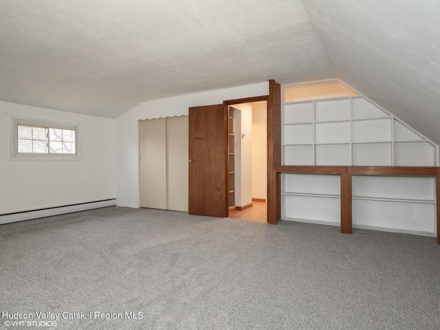 bonus room with carpet floors, a textured ceiling, vaulted ceiling, and baseboard heating