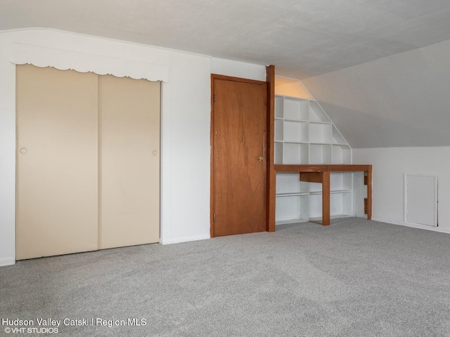 bonus room featuring carpet flooring and lofted ceiling