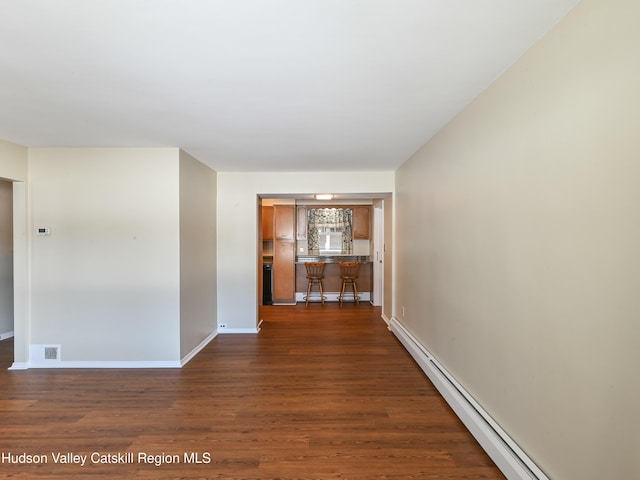 hall featuring dark hardwood / wood-style floors and baseboard heating