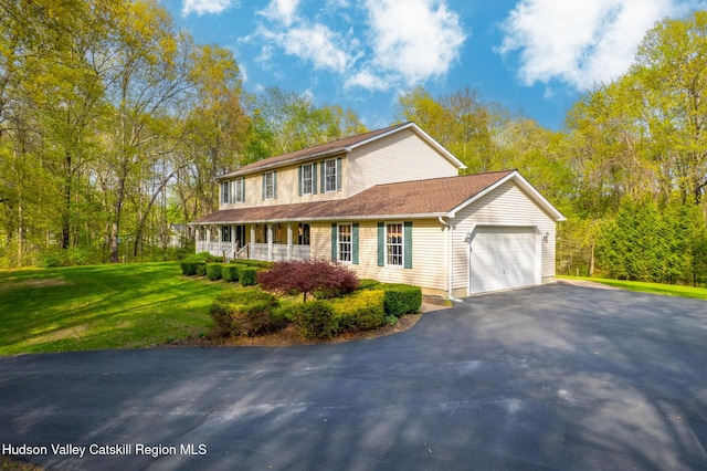 319 Garrison Woods Ln, Wallkill, NY 12589 - view of front of house with a porch, a garage, a front lawn, and driveway