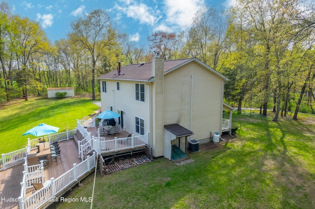 319 Garrison Woods Ln, Wallkill, NY 12589 - rear view of house with a chimney, a yard, outdoor dining space, central air condition unit, and a deck