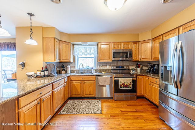 319 Garrison Woods Ln, Wallkill, NY 12589 - kitchen with a sink, tasteful backsplash, light stone counters, and appliances with stainless steel finishes