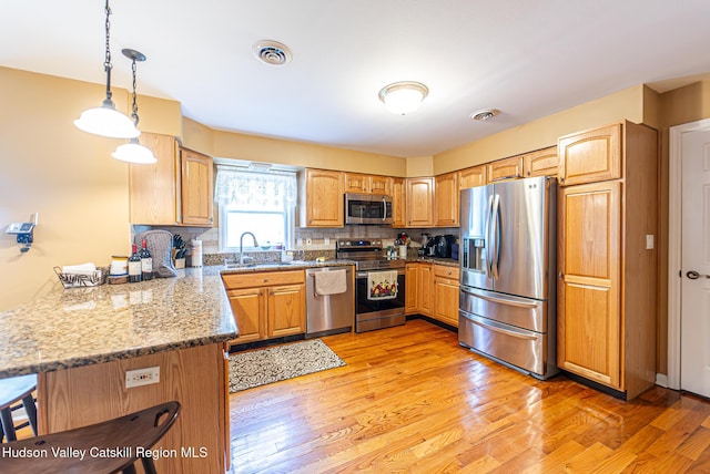 319 Garrison Woods Ln, Wallkill, NY 12589 - kitchen with pendant lighting, visible vents, a sink, a peninsula, and appliances with stainless steel finishes