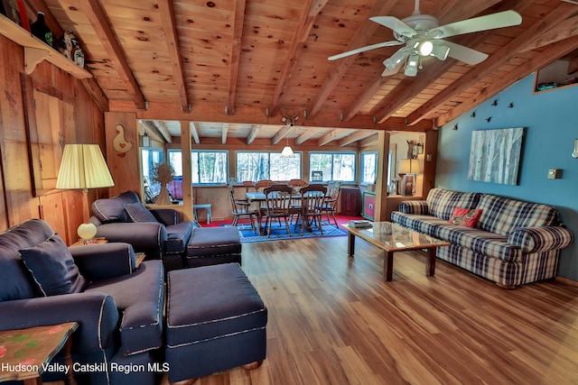 living room featuring wood ceiling, ceiling fan, wood-type flooring, lofted ceiling with beams, and wood walls