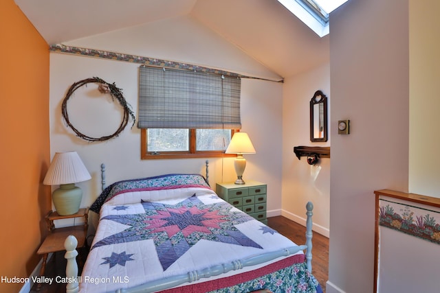 bedroom featuring multiple windows, wood-type flooring, and vaulted ceiling