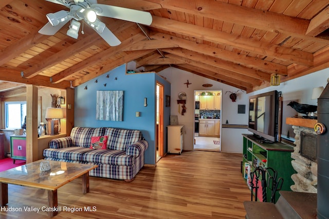 living room featuring vaulted ceiling with beams, light hardwood / wood-style flooring, and wood ceiling