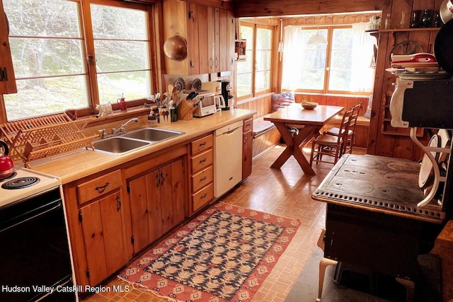 76 Smith Rd, Preston Hollow, NY 12469 - kitchen featuring white dishwasher, electric range, light countertops, wood walls, and brown cabinetry