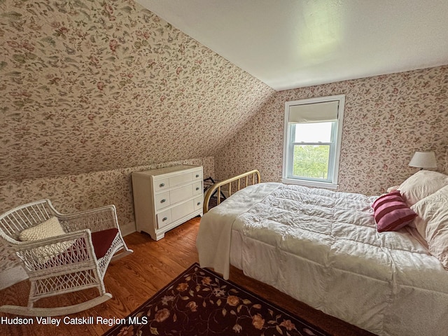 76 Smith Rd, Preston Hollow, NY 12469 - bedroom featuring wood finished floors, wallpapered walls, and lofted ceiling
