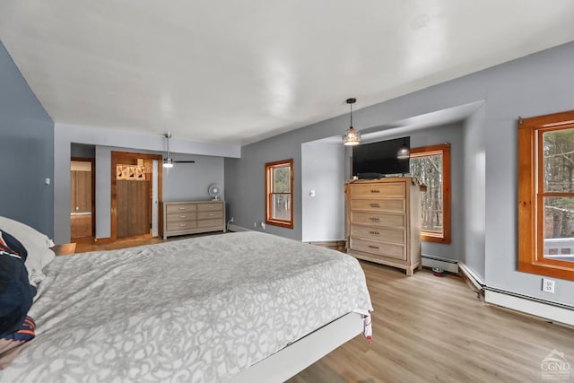 52 Bowman Rd, Chatham, NY 12037 - bedroom with wood finished floors and a baseboard heating unit