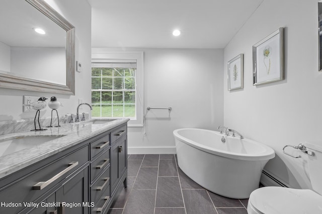 bathroom featuring a tub to relax in, tile patterned flooring, vanity, and a baseboard heating unit