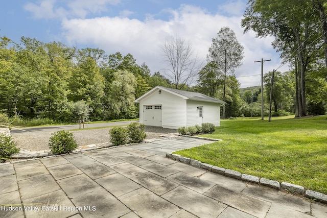 view of patio featuring a garage and an outdoor structure