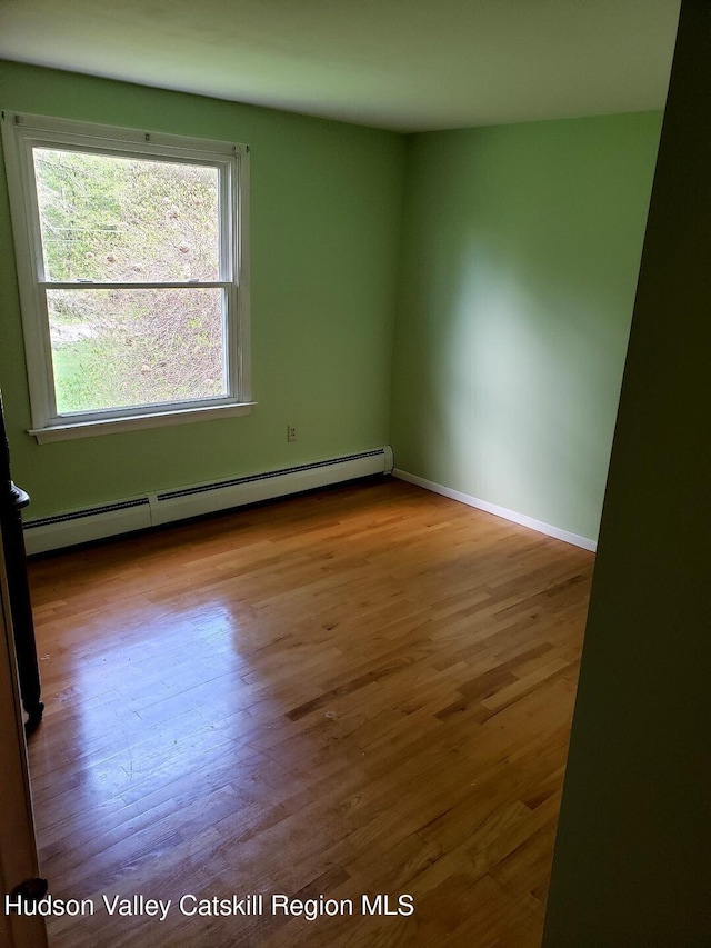 22 Katzman Rd, Ellenville, NY 12428 - unfurnished room featuring baseboard heating, wood finished floors, and baseboards