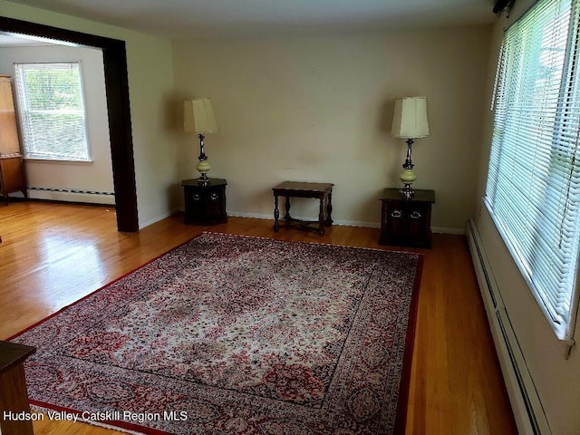 22 Katzman Rd, Ellenville, NY 12428 - living room with baseboard heating, wood finished floors, and baseboards
