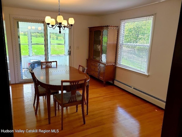 22 Katzman Rd, Ellenville, NY 12428 - dining space featuring a baseboard radiator, a chandelier, and light wood-style flooring