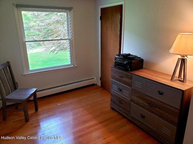 22 Katzman Rd, Ellenville, NY 12428 - bedroom with baseboard heating, multiple windows, and light wood-style flooring