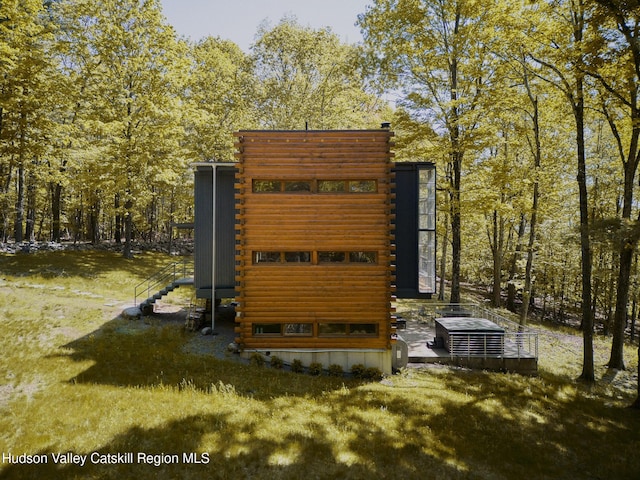 39 Hornbeck Ln, Accord, NY 12404 - exterior view of log siding and central AC
