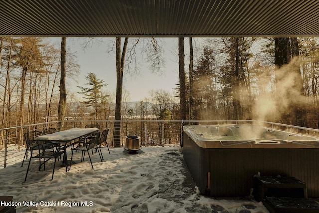 patio terrace at dusk featuring a hot tub