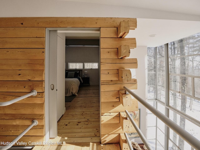 hall with hardwood / wood-style flooring and a healthy amount of sunlight