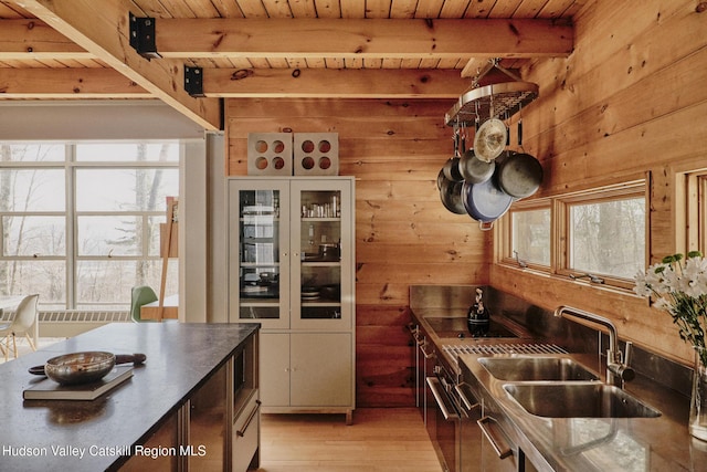 kitchen with beamed ceiling, sink, and wood ceiling