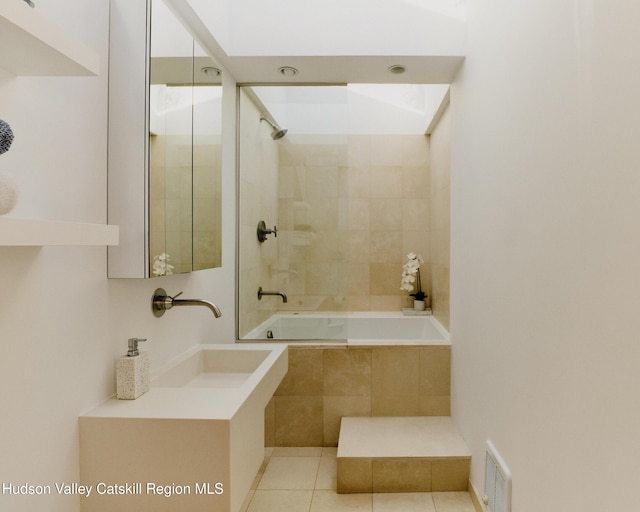 bathroom featuring tiled shower / bath, tile patterned floors, and sink