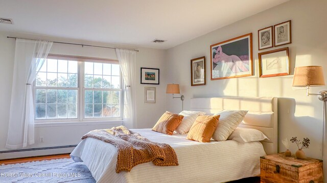 bedroom featuring visible vents and a baseboard radiator