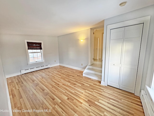 11 W Bridge St, Saugerties, NY 12477 - unfurnished bedroom with a baseboard heating unit, a baseboard radiator, light wood finished floors, and a closet
