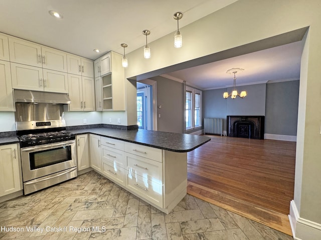 11 W Bridge St, Saugerties, NY 12477 - kitchen with gas range, under cabinet range hood, radiator, dark countertops, and a chandelier