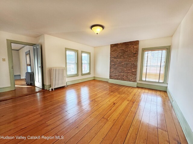 11 W Bridge St, Saugerties, NY 12477 - spare room with radiator, light wood-style floors, and healthy amount of natural light