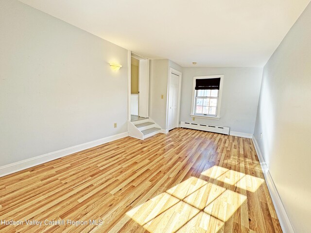 11 W Bridge St, Saugerties, NY 12477 - unfurnished room with a baseboard radiator and light wood-style flooring