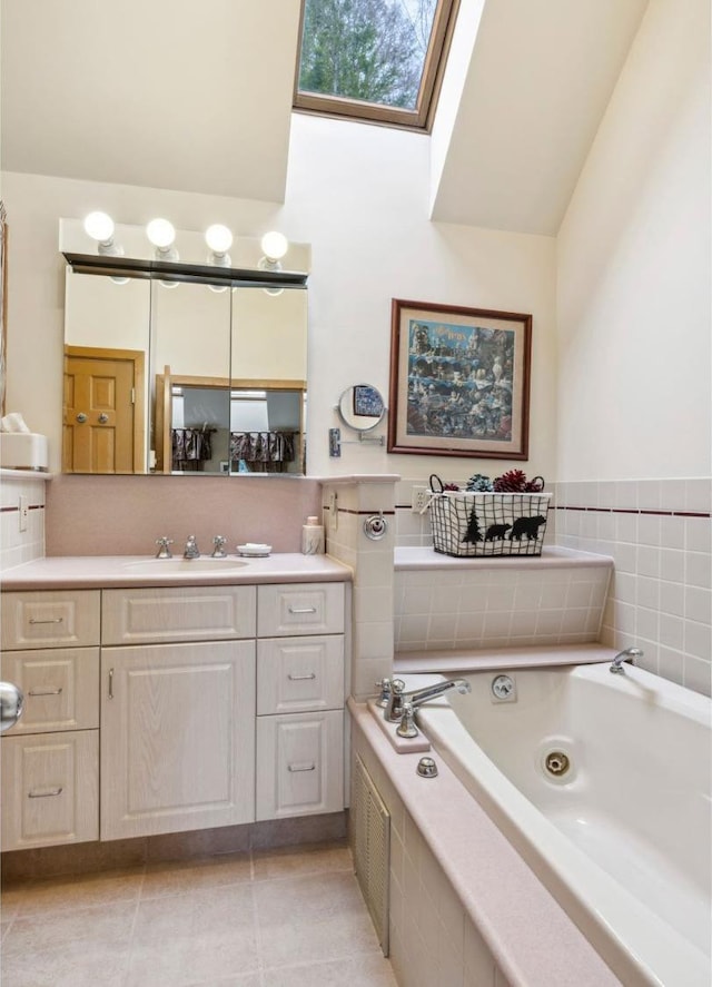 full bath with tile patterned flooring, a skylight, a whirlpool tub, vanity, and high vaulted ceiling