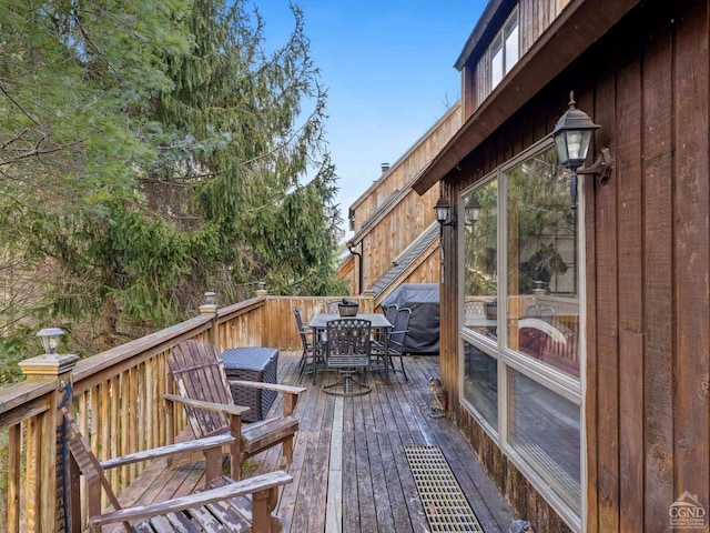 wooden terrace with outdoor dining space
