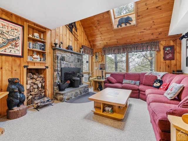 carpeted living area featuring vaulted ceiling, wood walls, and wood ceiling