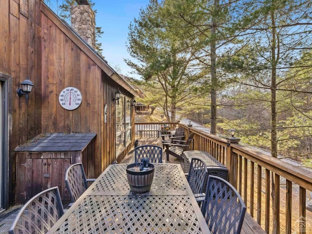 wooden terrace featuring outdoor dining area