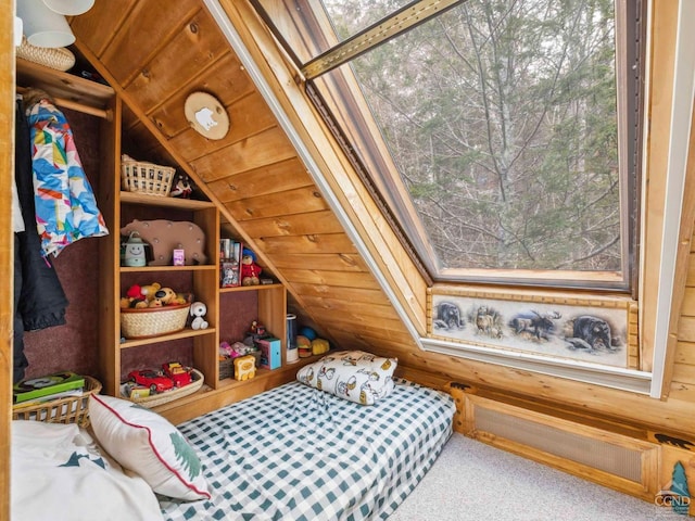 carpeted bedroom featuring lofted ceiling, wood walls, and wooden ceiling