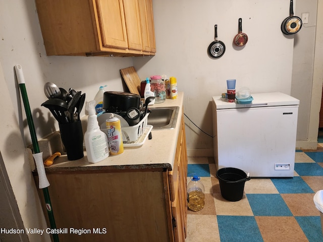 interior space featuring white fridge and sink