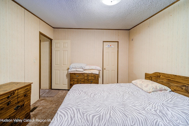 carpeted bedroom featuring crown molding and a textured ceiling