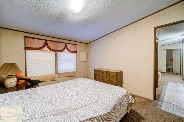 bedroom featuring light carpet, a textured ceiling, and crown molding