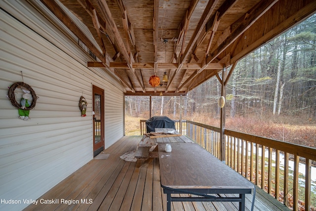 wooden deck with a grill