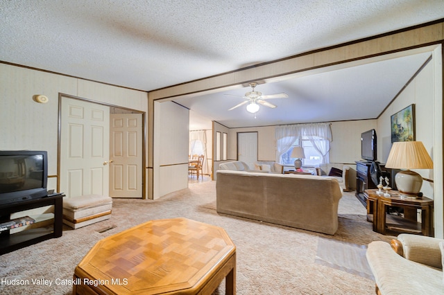 living area featuring light carpet, a textured ceiling, lofted ceiling, and ornamental molding