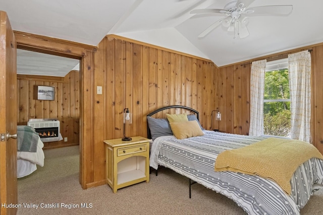 194 High Falls Rd, Saugerties, NY 12477 - bedroom with heating unit, vaulted ceiling, wooden walls, carpet, and a warm lit fireplace