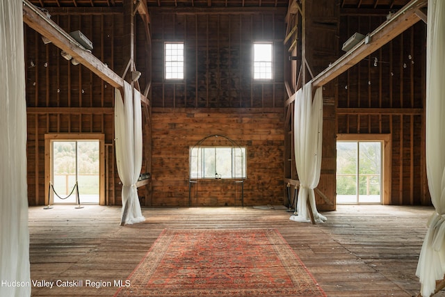 394 Macmore Rd, Roxbury, NY 12474 - misc room featuring healthy amount of natural light, hardwood / wood-style floors, a high ceiling, and wooden walls