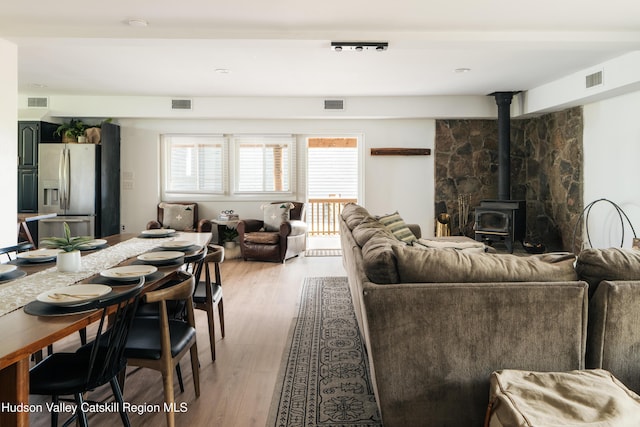 394 Macmore Rd, Roxbury, NY 12474 - living room with a wood stove and light wood-type flooring