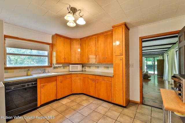 18 Maplewood Ave, Windham, NY 12496 - kitchen featuring black dishwasher, white microwave, light countertops, decorative backsplash, and a chandelier